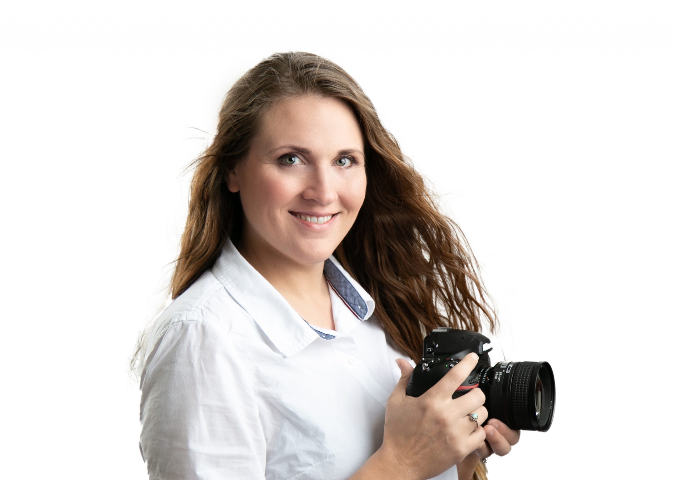 headshot of woman in white shirt holding a camera