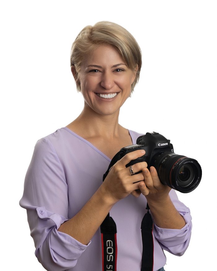 Headshot of woman holding camera