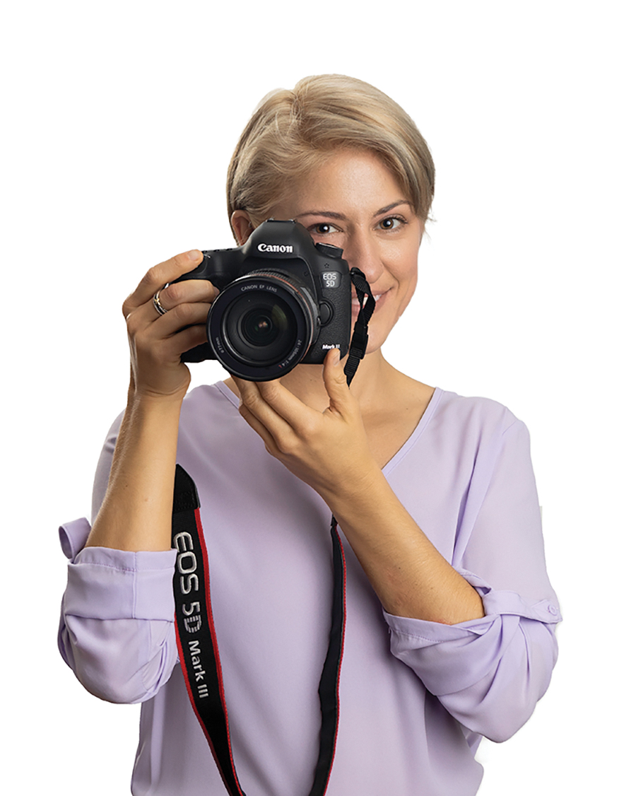 woman holding professional camera up to face