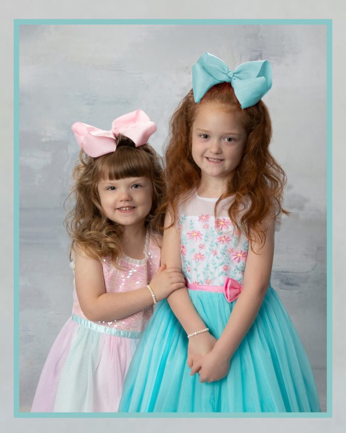 2 little girls with big pastel bows